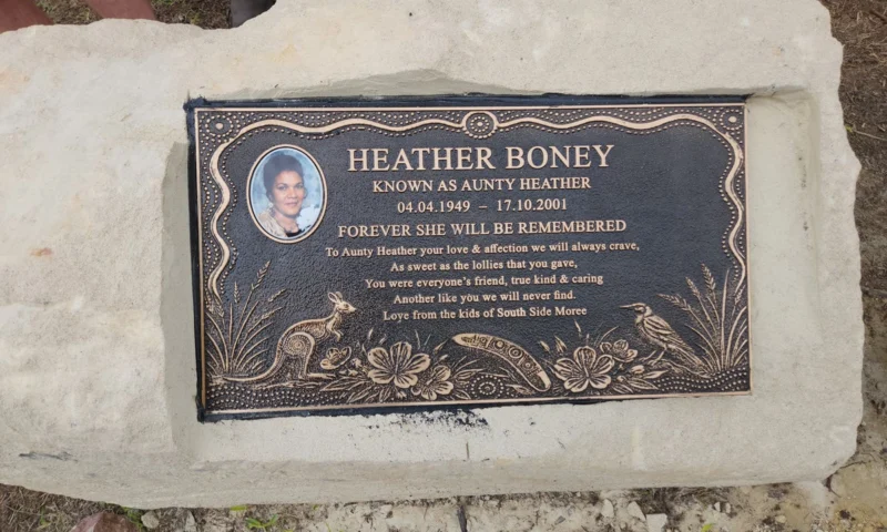 The memorial plaque for Aunty Heather Boney at Wales Park, Moree, showing her portrait, her dates and the verse signed by the kids of South Side Moree.