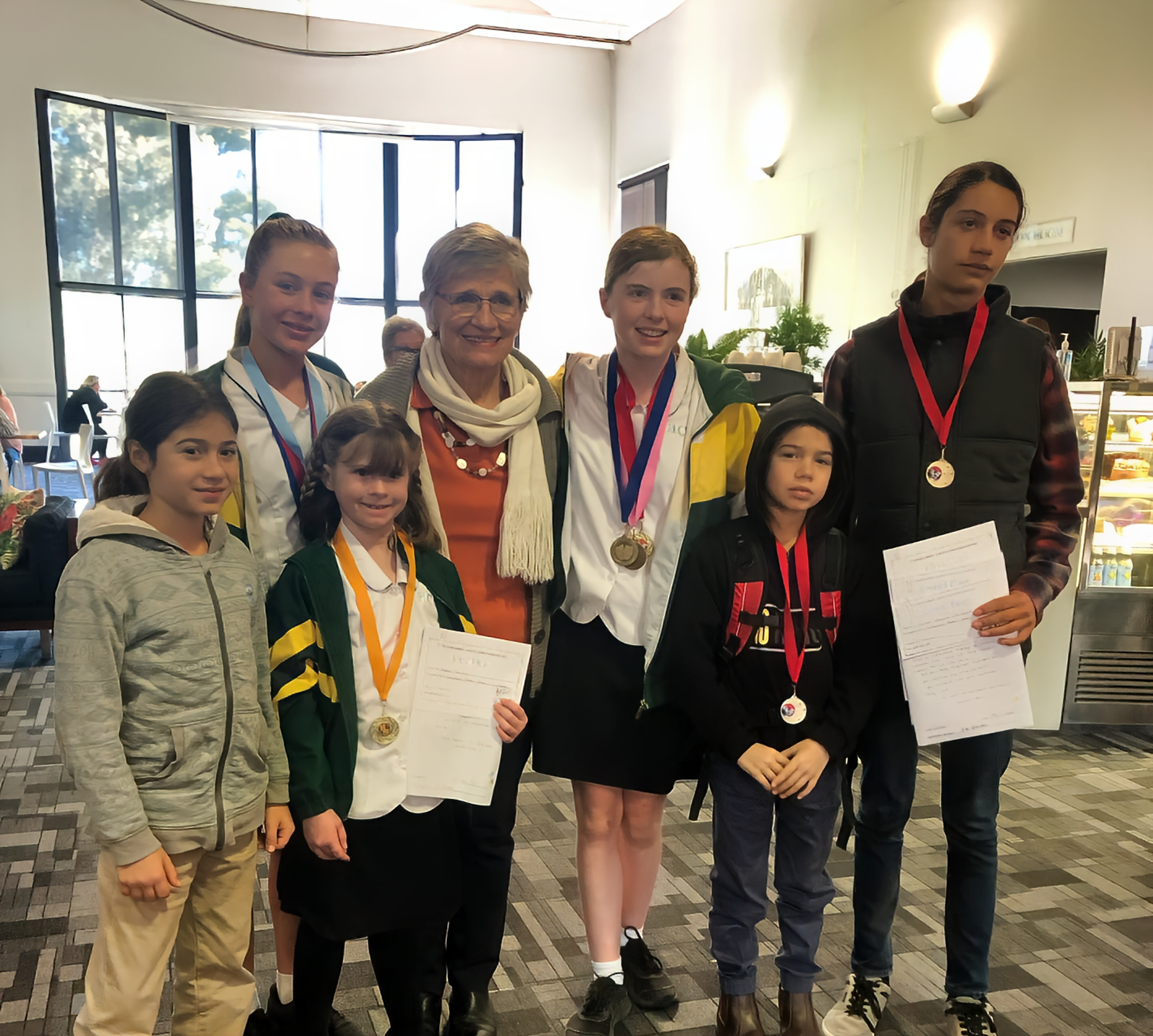 Nishant (Year 4), Holly (Year 7), Mabel (Year 1), teacher Nora Carrigan, Josie (Year 8), Sunjai (Year 2) and Kareb (Year 8).