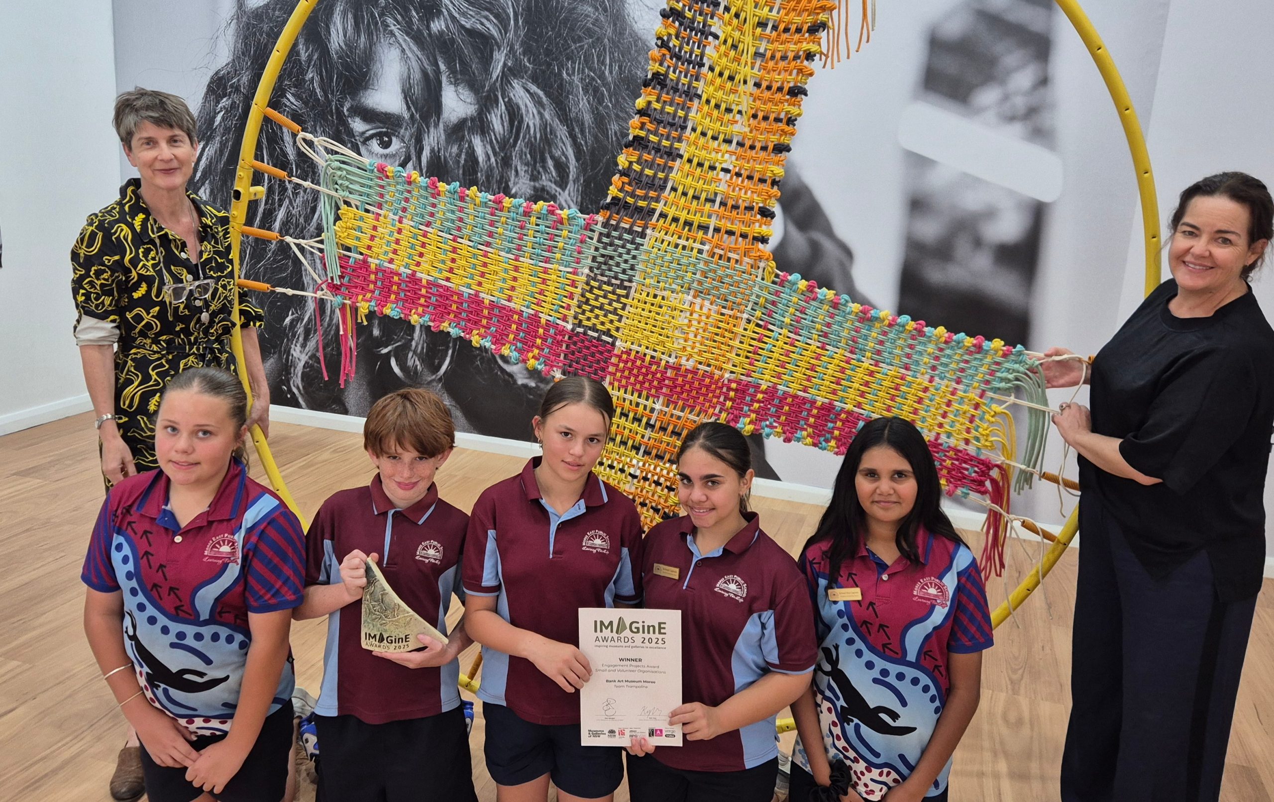 (from left) BAMM director Rosie Dennis, Moree East Public School students Issy Goodworth, Bruce Hines, Lara Humphries, Kayleigh Sampson and Lacie Hippi, with artist Meg Wilson and part of the Team Trampoline project, a major winner at the recent Museum and Galleries NSW IMAGinE Awards.